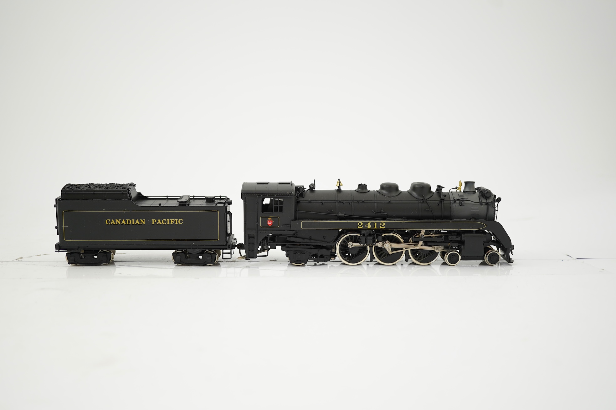 Two boxed HO gauge Canadian Pacific locomotives; a Toby of Japan model of 2412, 4-6-2 locomotive with bogie tender, together with a United Scale Models 3710, 2-8-0 locomotive with bogie tender, both powered for two rail